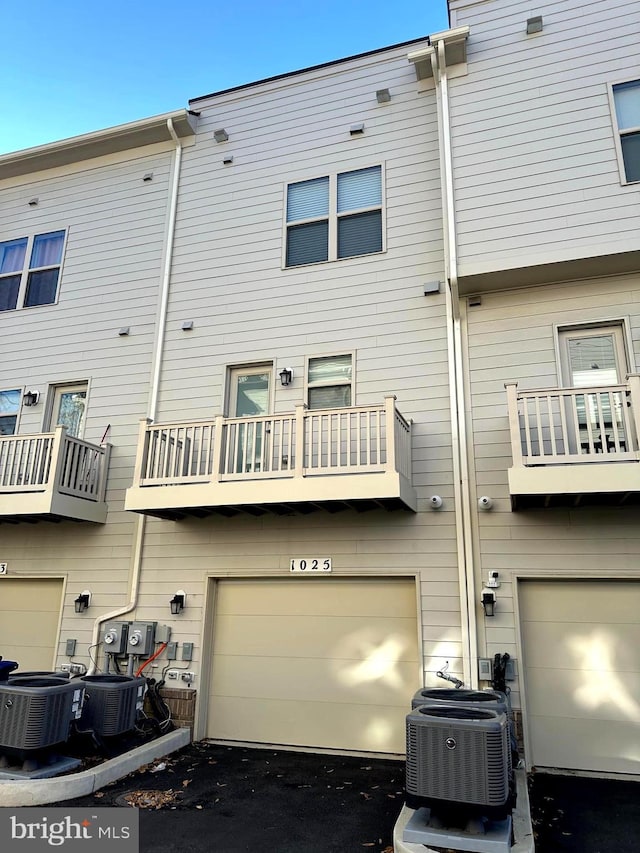 rear view of house featuring central AC