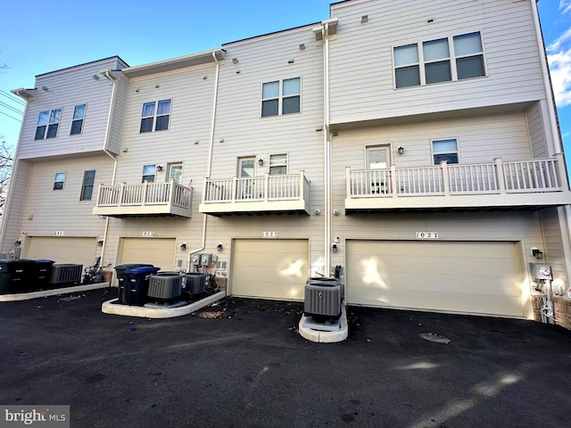 rear view of house featuring central AC