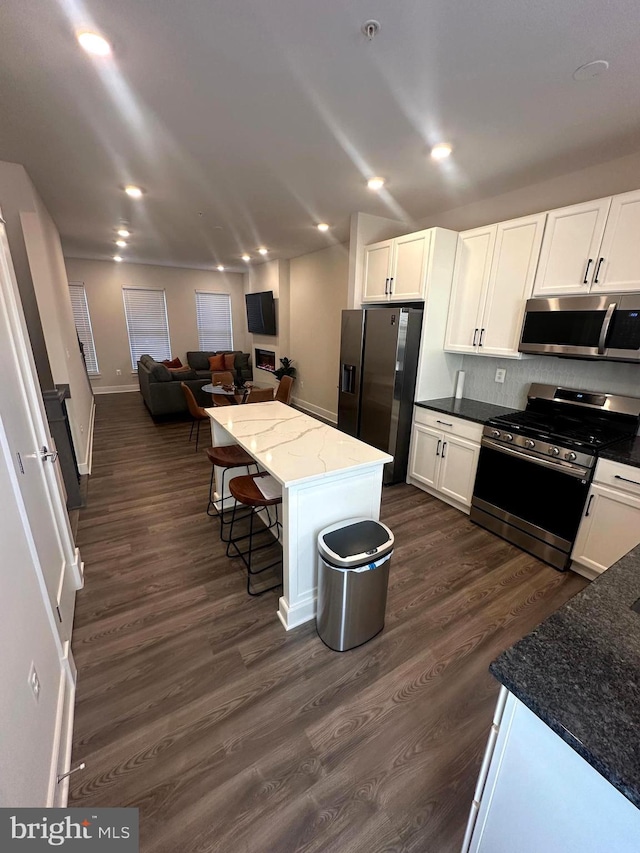 kitchen featuring white cabinets, a center island, and appliances with stainless steel finishes