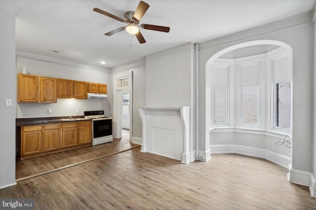 kitchen with ceiling fan, white range oven, and light wood-type flooring