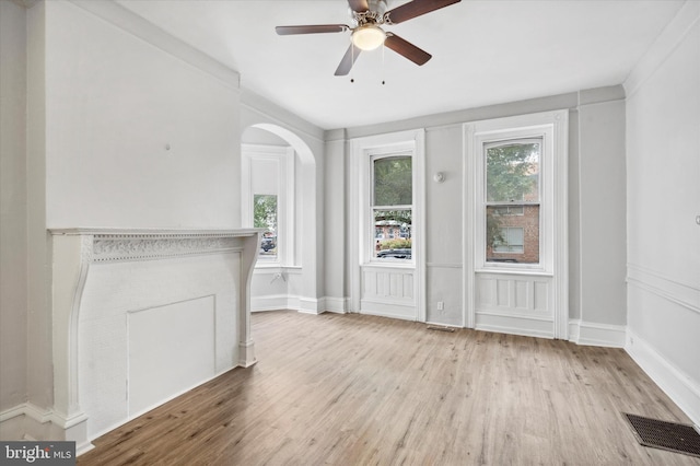 interior space with a wealth of natural light, light hardwood / wood-style flooring, and ceiling fan