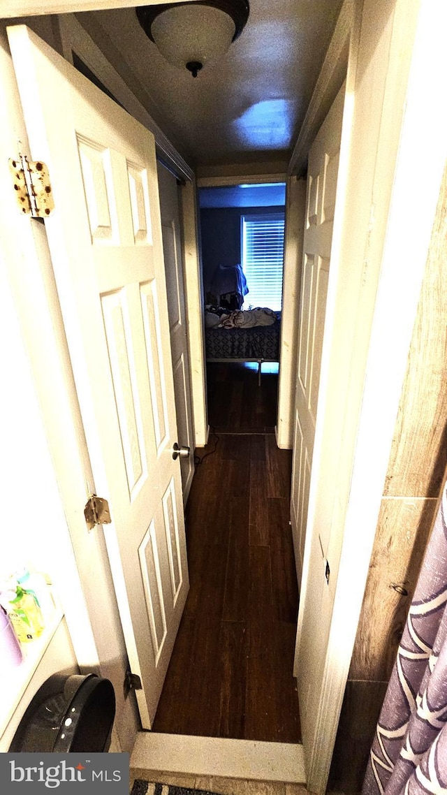 hallway with dark hardwood / wood-style floors