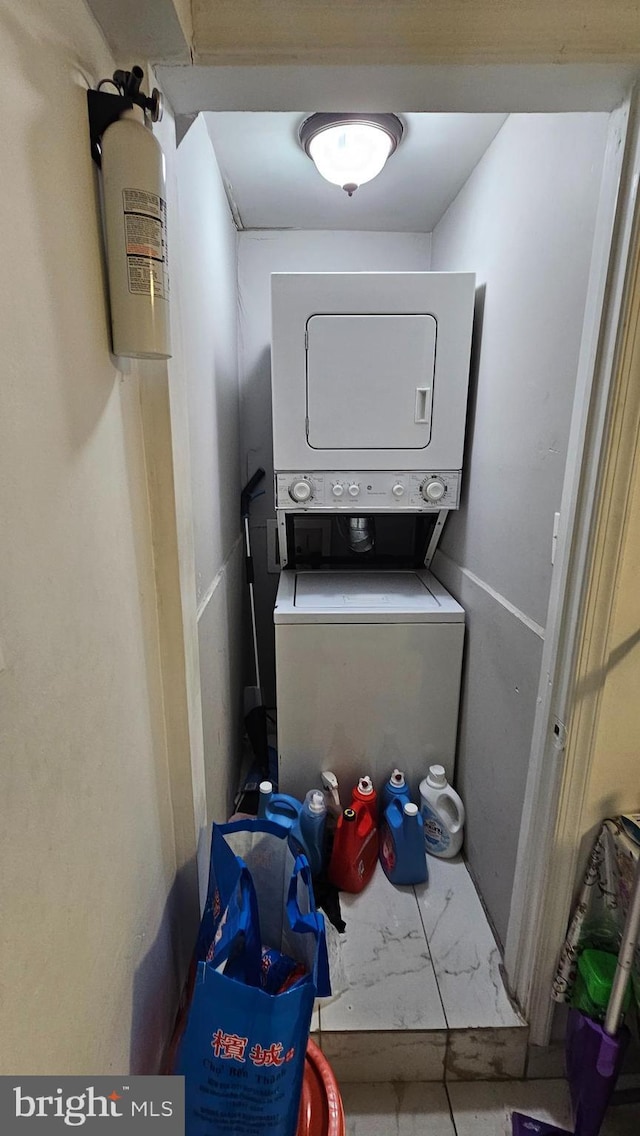 laundry area with stacked washing maching and dryer