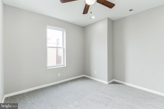 spare room with light carpet and ceiling fan