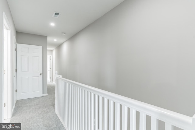 hall featuring light colored carpet