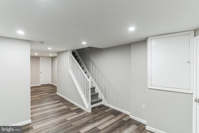 stairs featuring hardwood / wood-style floors