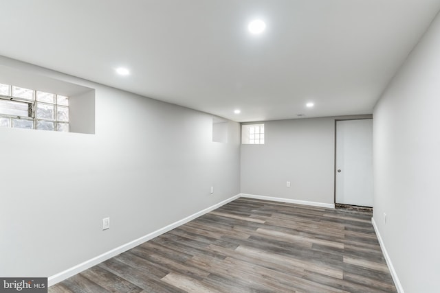 basement with dark hardwood / wood-style flooring