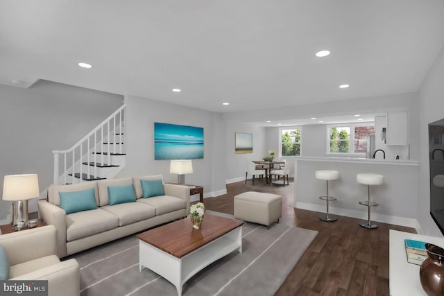 living room featuring hardwood / wood-style floors and sink