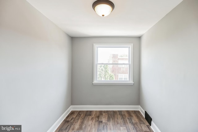 spare room featuring dark hardwood / wood-style flooring