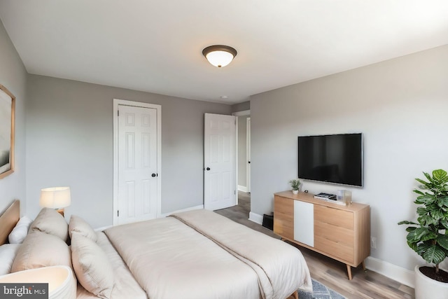 bedroom with wood-type flooring