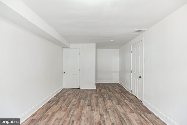 unfurnished room with dark wood-type flooring