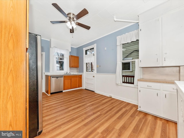 kitchen featuring white cabinetry, ceiling fan, light hardwood / wood-style floors, and appliances with stainless steel finishes