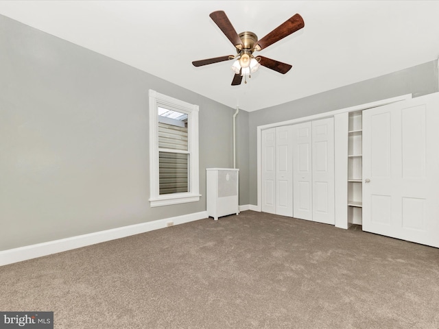 unfurnished bedroom featuring ceiling fan, a closet, and carpet