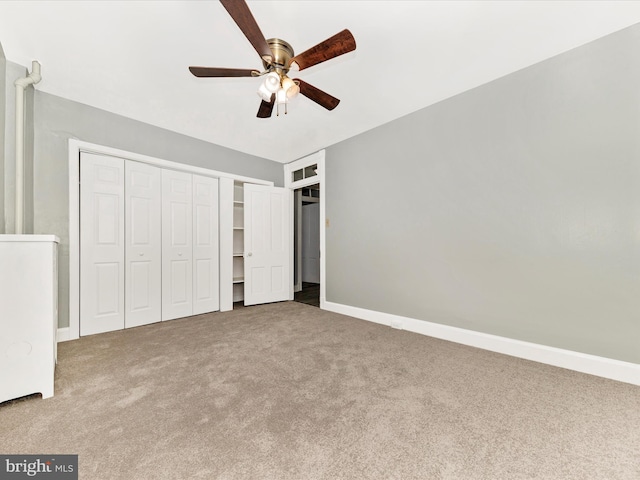 unfurnished bedroom featuring ceiling fan, a closet, and carpet