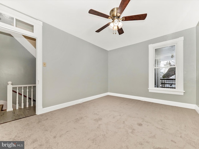 carpeted spare room with ceiling fan