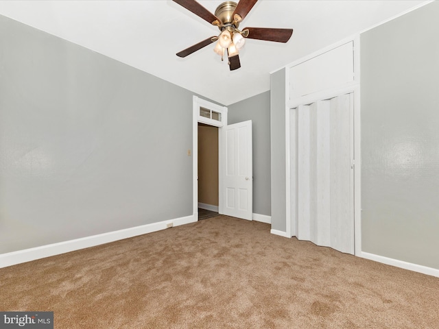 unfurnished bedroom with ceiling fan and light colored carpet