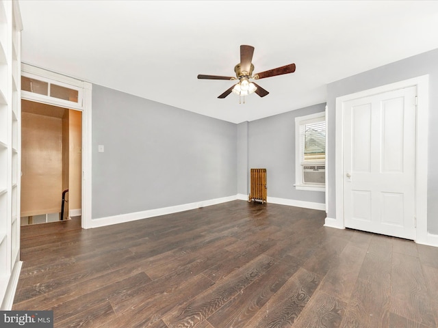 unfurnished living room featuring cooling unit, ceiling fan, and dark wood-type flooring