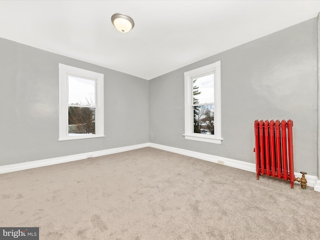 carpeted spare room with radiator