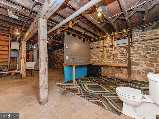 interior space featuring concrete floors and toilet