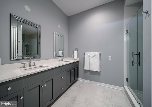 bathroom with a shower with door and vanity