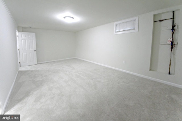 basement featuring light colored carpet