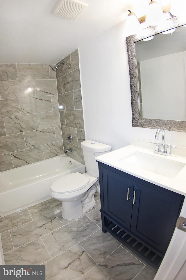 full bathroom featuring vanity, toilet, and tiled shower / bath