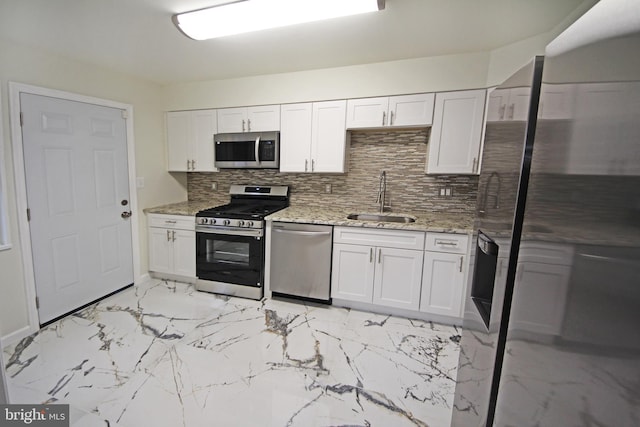 kitchen with white cabinets, appliances with stainless steel finishes, and sink