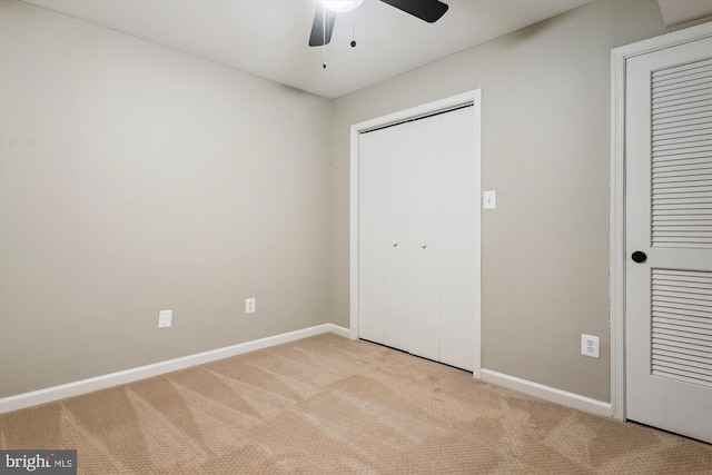 unfurnished bedroom featuring light colored carpet and ceiling fan