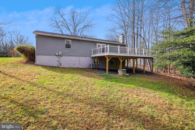 back of house featuring a yard, a deck, and central AC unit