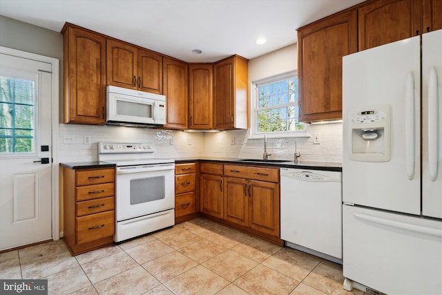 kitchen featuring light tile patterned flooring, white appliances, backsplash, and sink