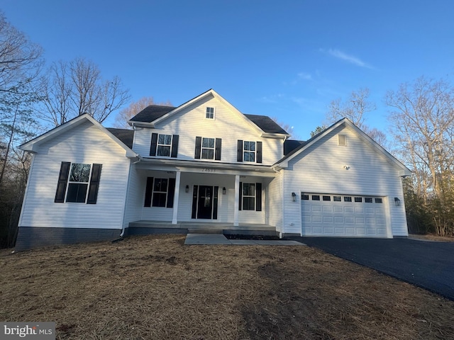 front of property featuring a porch and a garage