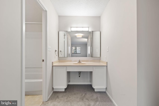 bathroom with vanity and a textured ceiling