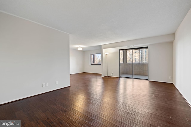 spare room with dark hardwood / wood-style floors