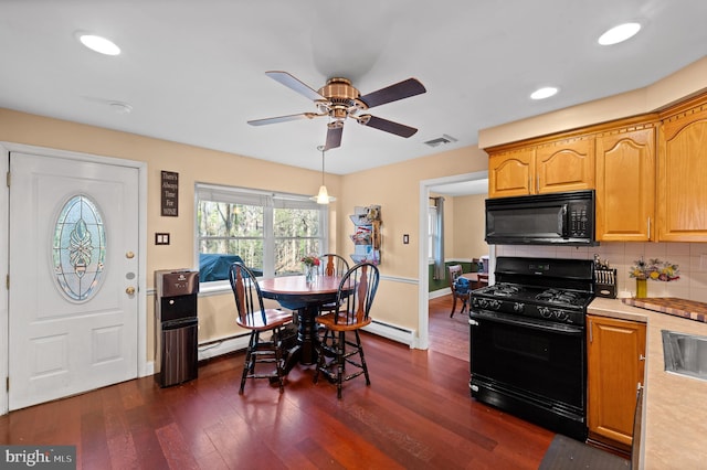 kitchen featuring ceiling fan, a baseboard radiator, dark hardwood / wood-style floors, backsplash, and black appliances