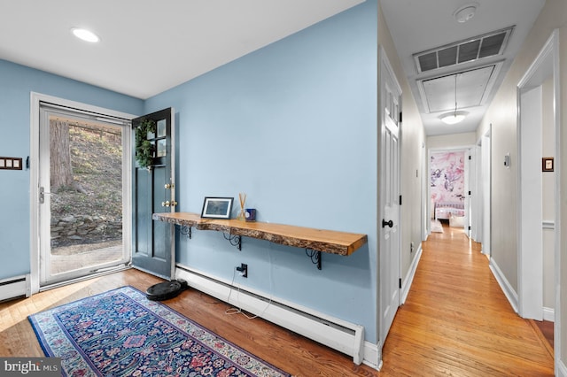 entryway featuring light hardwood / wood-style floors and a baseboard heating unit