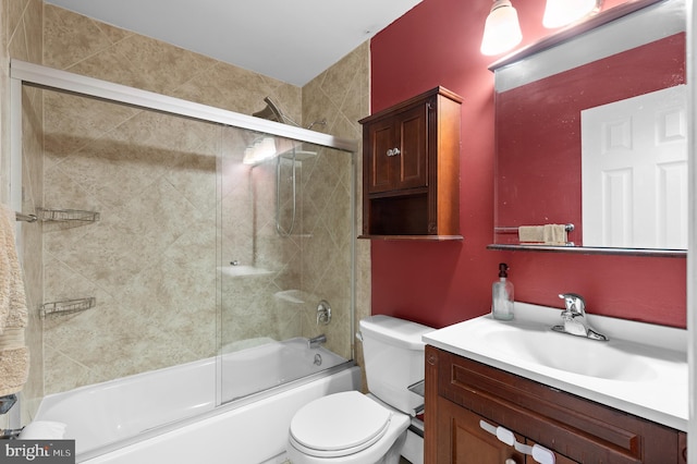 full bathroom with shower / bath combination with glass door, vanity, and toilet