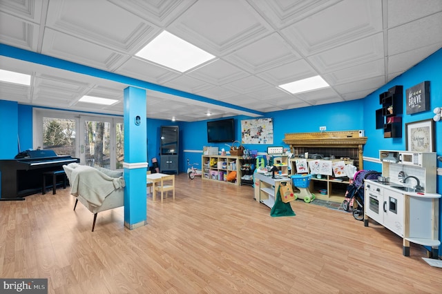 recreation room featuring french doors and hardwood / wood-style flooring