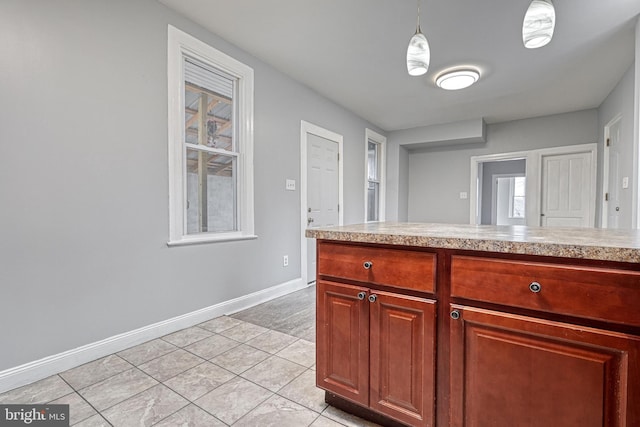 kitchen with plenty of natural light and hanging light fixtures