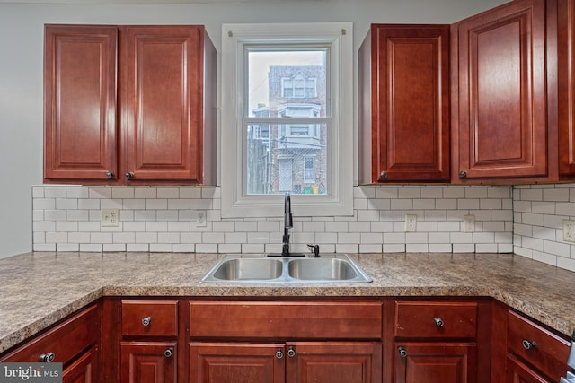 kitchen featuring backsplash and sink