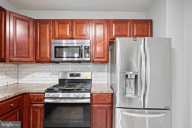 kitchen with decorative backsplash, light stone countertops, and stainless steel appliances