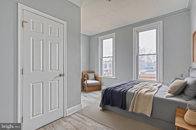 bedroom featuring light hardwood / wood-style floors and ornamental molding