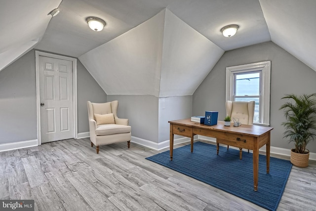 office space with light hardwood / wood-style floors and lofted ceiling