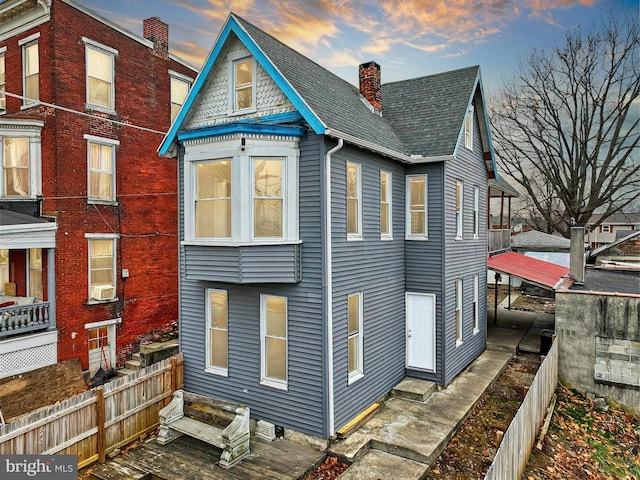 view of back house at dusk