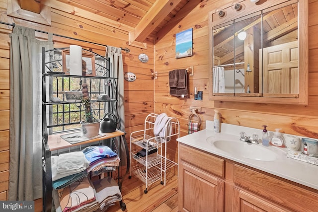 bathroom with vanity, lofted ceiling with beams, wooden ceiling, and wooden walls