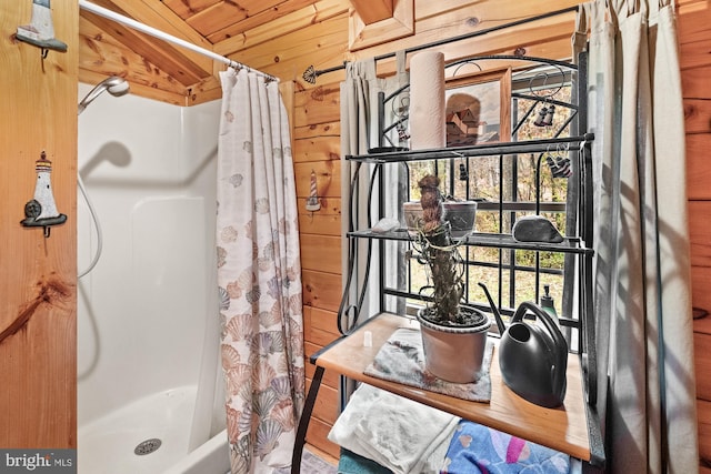 bathroom with a shower with curtain, wood walls, wooden ceiling, and vaulted ceiling