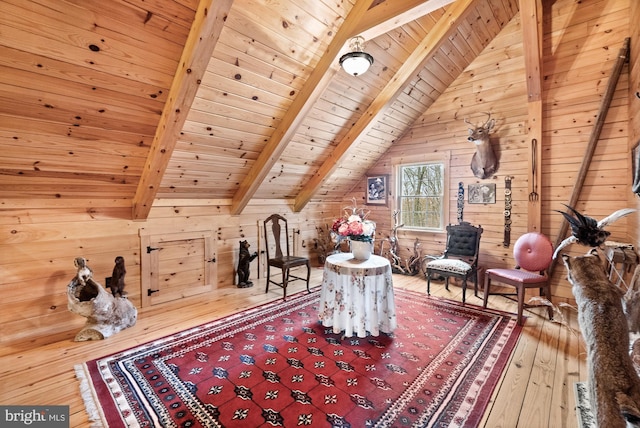 unfurnished room featuring hardwood / wood-style floors, vaulted ceiling with beams, wood walls, and wood ceiling