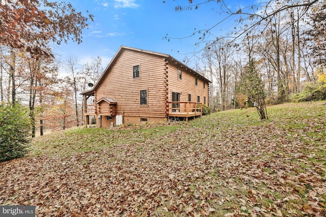 view of property exterior with a deck