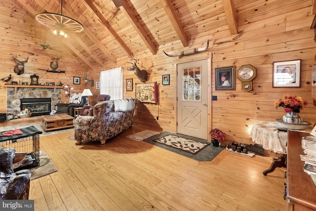 living room featuring beam ceiling, high vaulted ceiling, wood walls, wood ceiling, and hardwood / wood-style flooring