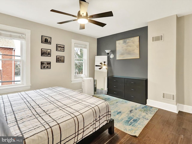 bedroom with ceiling fan and dark wood-type flooring