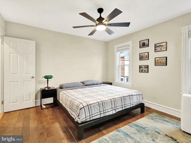 bedroom featuring dark hardwood / wood-style flooring and ceiling fan